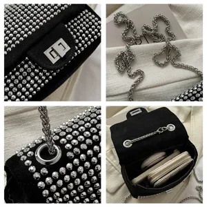 Close-up detail shot of black studded crossbody bag showcasing metal chain and rhinestone texture.