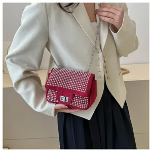 Red rhinestone shoulder bag for women, stylish crossbody purse with chic chain and lock closure.