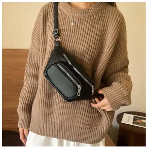 Black faux leather sling bag detail with zippers and adjustable strap for daily use.