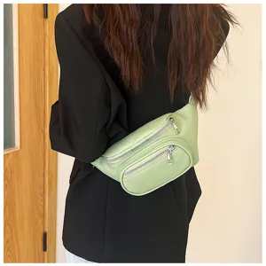 Light green casual women waist bag detail view showing dual zipper pockets and strap.