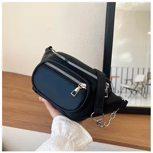 Black casual fanny pack detail, multi zipper pockets and metal chain decoration style.