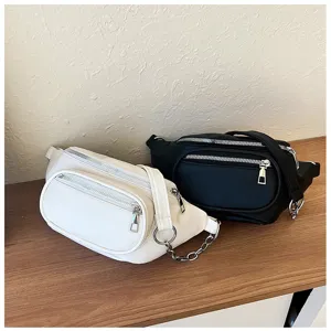 Detailed view of casual women fanny pack with stylish chain and metal zippers, elegant texture.