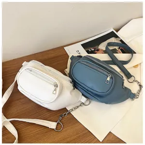 Detailed view of casual women's waist bag featuring dual zipper pockets and stylish chain strap.
