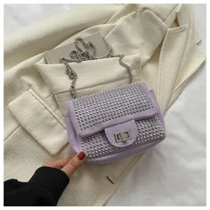 Chic lavender rhinestone shoulder bag with metal chain strap and elegant flap turn-lock design.