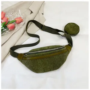 Riñonera de pana verde con detalle de monedero pequeño y correa ajustable para el pecho.