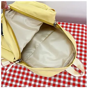 Cute yellow children school backpack detail, featuring inner compartment and smooth zipper.