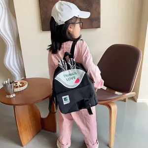 Cute children canvas backpack with cute bunny ears and watermelon print for daily use.