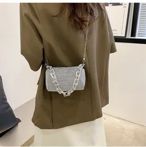 Sparkly rhinestone shoulder bag detail showing stylish chunky chain and exquisite crystal surface.
