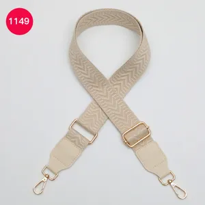 Detailed view of wide adjustable replacement bag strap in beige chevron woven fabric design.