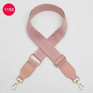 Pink replacement bag strap with woven chevron pattern, adjustable length and gold hardware.
