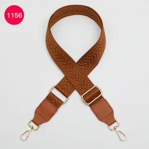 Adjustable brown woven shoulder strap with leather ends and gold hardware for crossbody bags.