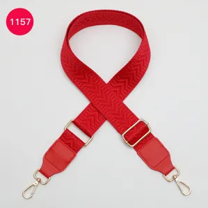 Red woven replacement bag strap with adjustable metal buckles and leather ends for crossbody.