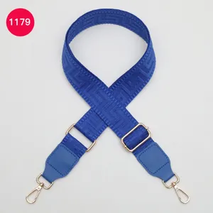 Blue wide replacement bag strap with Greek key pattern, adjustable length and metal clasps.