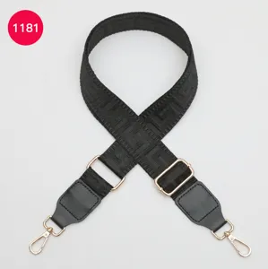 Black woven replacement bag strap with gold metal hardware, detailed adjustable shoulder strap.