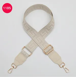 Beige wide replacement bag strap with geometric labyrinth pattern and gold hardware.