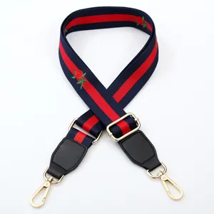 Replacement handbag strap with embroidered rose and classic web stripe design for shoulder bags.