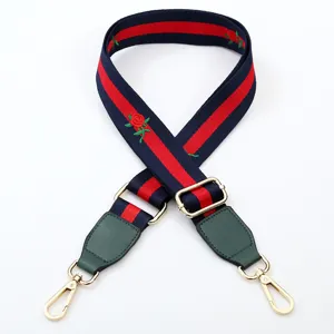 Replacement bag strap, blue and red web design with embroidered roses and gold hardware.