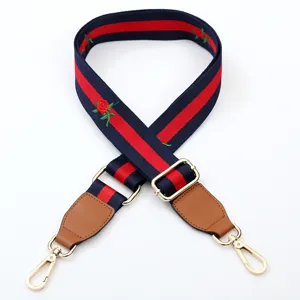 Replacement handbag strap with red blue web stripe and embroidered rose flowers, adjustable length.