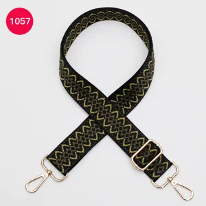 Adjustable replacement bag strap with metallic hardware and geometric woven pattern for crossbody bags.