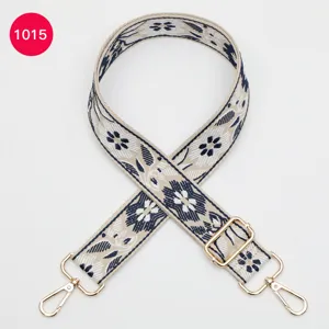 Ethnic jacquard replacement bag strap with floral pattern, adjustable gold hardware.