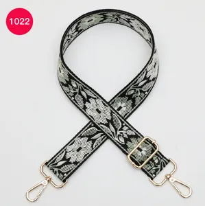 Ethnic jacquard wide bag strap replacement with gold hardware, stylish crossbody design.