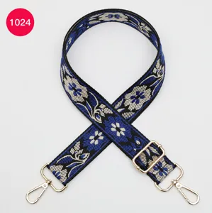 Ethnic style jacquard wide bag strap replacement with gold hardware and floral pattern design.