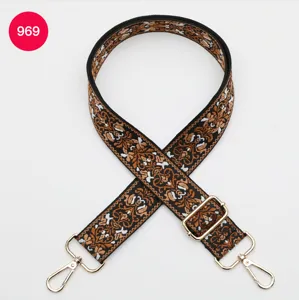 Ethnic jacquard wide bag strap replacement with adjustable gold metal hardware and hooks.