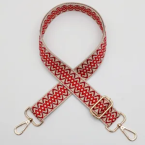 Adjustable replacement bag strap with red geometric woven pattern and gold metal hardware.