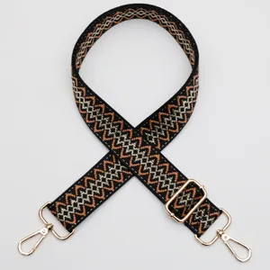 Ethnic woven replacement bag strap with adjustable gold hardware and hooks for crossbody bags.