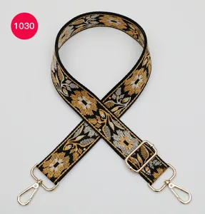 Ethnic style embroidered bag strap with golden floral pattern, adjustable metal hardware.