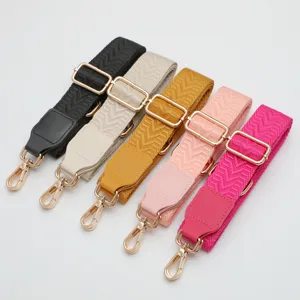 Adjustable wide bag strap replacement with chevron pattern and gold hardware, crossbody style.