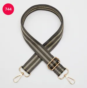 Adjustable wide replacement bag strap with striped woven design and gold hardware.