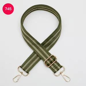 Adjustable wide canvas bag strap replacement with gold hardware, stylish green striped design.