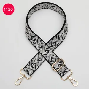 Détail de sangle de sac jacquard noir et blanc, bandoulière tissée réglable.