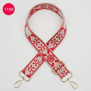 Ethnic woven bag strap detail, beige and red jacquard fabric with gold hardware, adjustable.