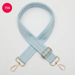 Light blue woven bag strap with silver stripes and gold metal hardware, adjustable.