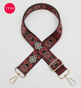 Detailed view of ethnic jacquard wide bag strap, featuring metal clasps and adjustable buckle.
