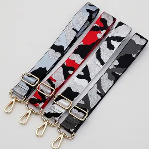 Adjustable wide replacement bag strap with camo pattern and gold tone metal hardware for crossbody.