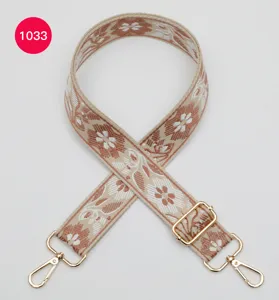 Ethnic floral jacquard wide bag strap with gold metal hardware, perfect crossbody accessory.