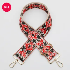 Ethnic jacquard wide bag strap with red black embroidery and gold hardware replacement.