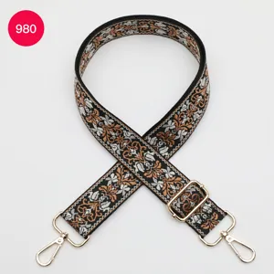 Adjustable woven bag strap with ethnic jacquard pattern and gold hardware for crossbody bags.