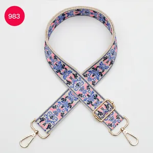 Colorful ethnic jacquard bag strap detail, adjustable with gold metal hardware hooks.