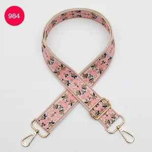 Woven ethnic style wide bag strap with adjustable buckle and gold metal hooks for bags.
