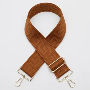 Brown wide replacement bag strap with adjustable length and gold hardware, chic geometric.