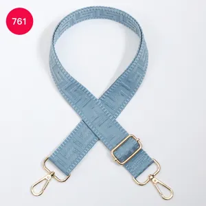 Blue replacement bag strap with adjustable gold hardware and geometric maze woven pattern.