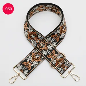Detailed view of the ethnic jacquard replacement bag strap with golden metal clasps and hooks.