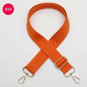 Courroie de sac tissée orange avec quincaillerie métallique réglable, accessoire élégant.