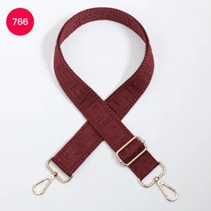 Adjustable wide replacement bag strap with geometric maze pattern and gold metal swivel hooks.