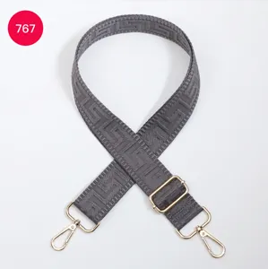 Grey geometric replacement bag strap detail, adjustable length with gold tone metal hardware.