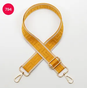 Adjustable wide replacement bag strap with golden labyrinth woven geometric pattern.